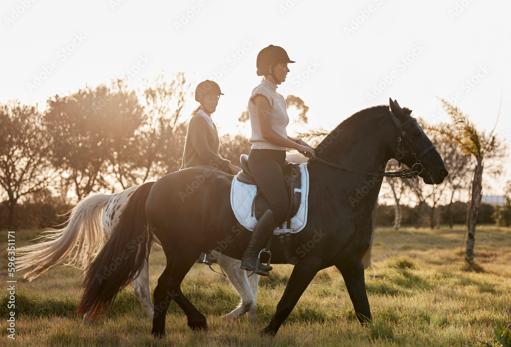Viewing nature from an alternate perspective. Shot of two young women out horseback riding together. Viewing nature from an alternate perspective. Shot of two young women out horseback riding together.