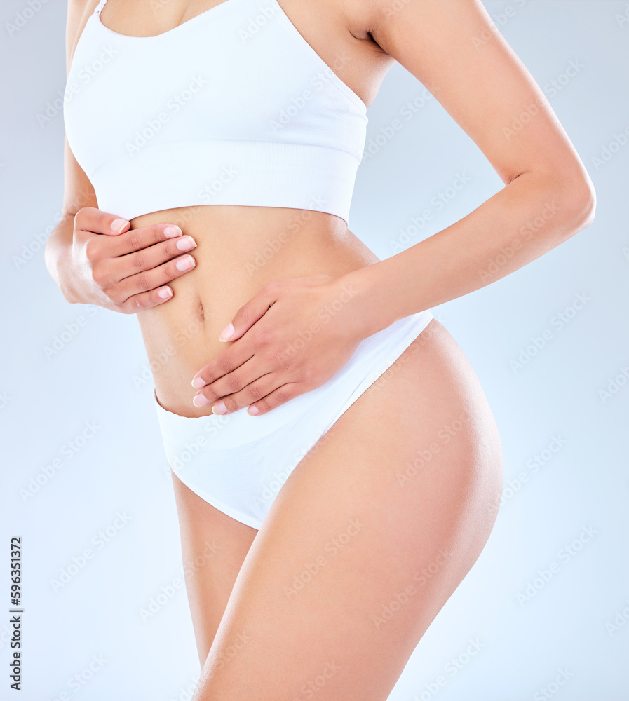 You are one routine away from a good mood. Shot of an unrecognizable woman posing with her hands around her belly against a grey background.