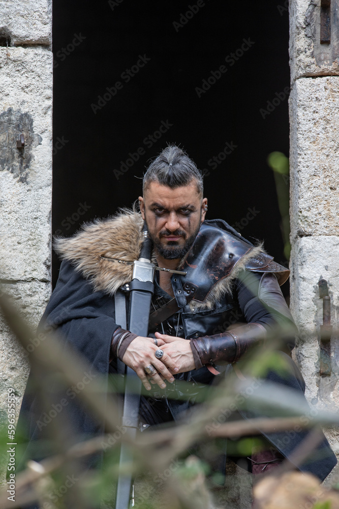Handsome man dressed as a warrior in costume Handsome man dressed as a warrior in costume