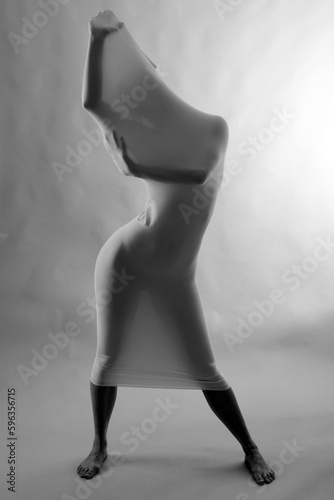 Model poses in a tube of stretchy fabric in studio