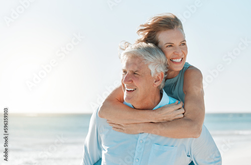 Were having a lovely day at the beach. Shot of a mature couple spending time together at the beach. photo