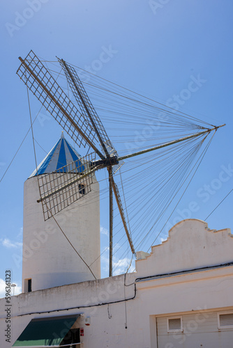 old original Moli de Dalt windmill on the roof of a house in sant lluis