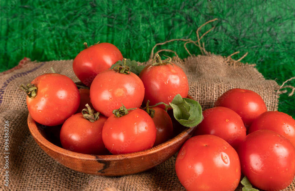 Fresh red tomatoes with water drops on a dark background. Harvesting tomatoes. Top view Fresh red tomatoes with water drops on a dark background. Harvesting tomatoes. Top view