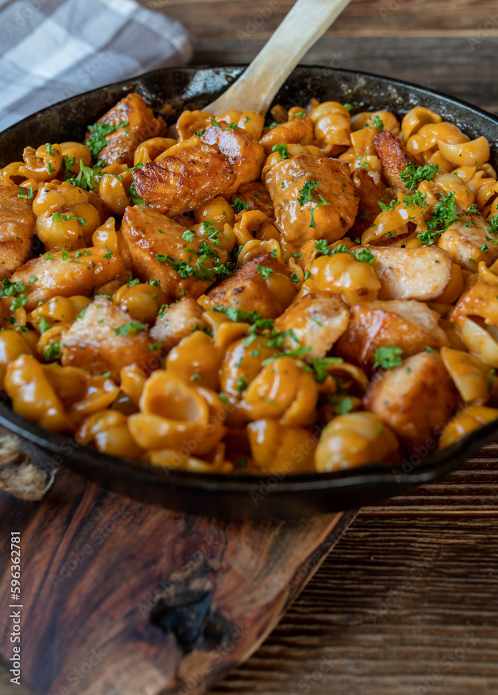 Creamy salmon with pasta shells in a cast iron pan Creamy salmon with pasta shells in a cast iron pan