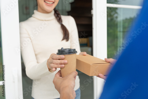 Happy smiling Asian woman receives paper box parcel of food from courier front house. Delivery man send deliver express. online shopping, paper container, takeaway, postman, delivery service, packages