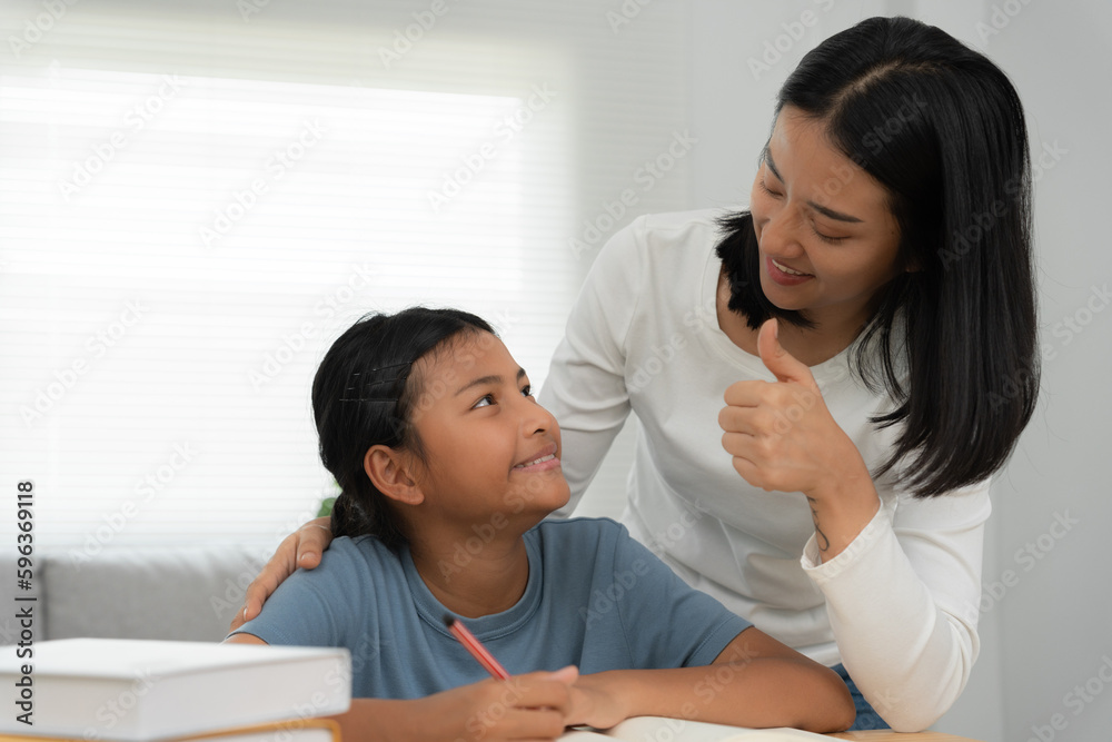 Mother teaching lesson for daughter. Asian young little girl learn at home. Do homework with kind mother help, encourage for exam.. Girl happy Homeschool. Mom advice education together. Mother teaching lesson for daughter. Asian young little girl learn at home. Do homework with kind mother help, encourage for exam.. Girl happy Homeschool. Mom advice education together.