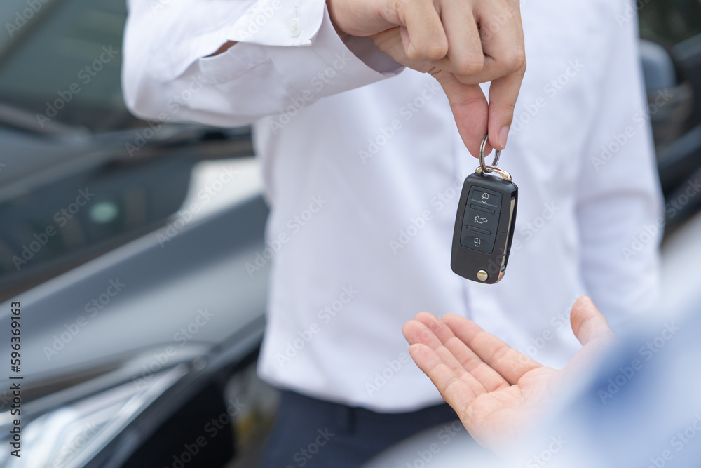Fototapeta premium lease, rental car, sell, buy. Dealership manager send car keys to the new owner. Sales, loan credit financial, rent vehicle, insurance, renting, Seller, dealer, installment, car care business..
