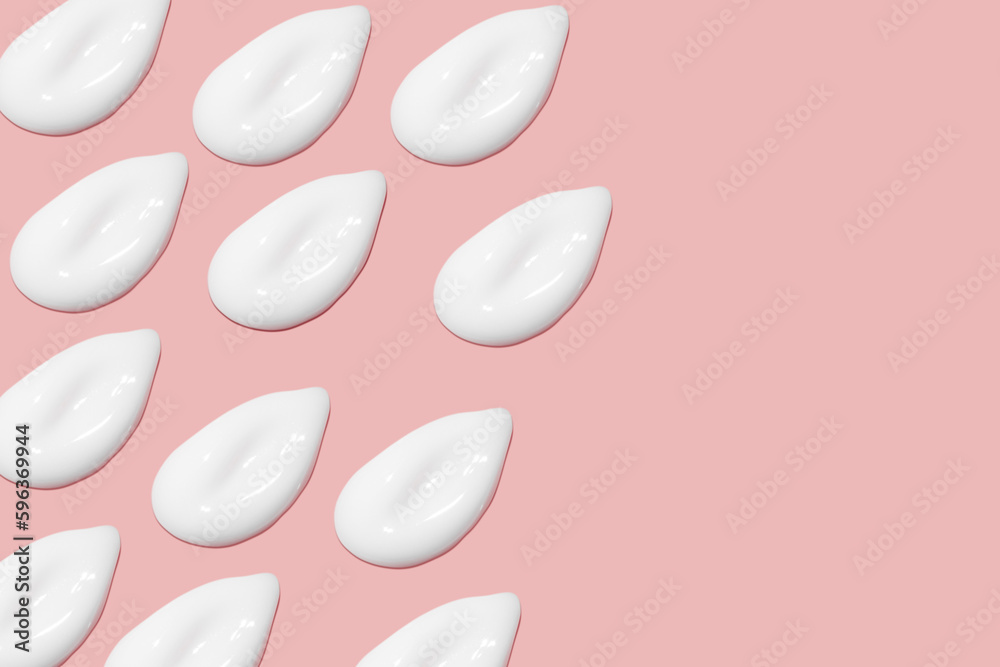 Lots of smears of cosmetic cream. Light, smooth surface. Texture of spreadable cream. Liquid creamy strokes. On a pink background. Cosmetic background, banner. Lots of smears of cosmetic cream. Light, smooth surface. Texture of spreadable cream. Liquid creamy strokes. On a pink background. Cosmetic background, banner.
