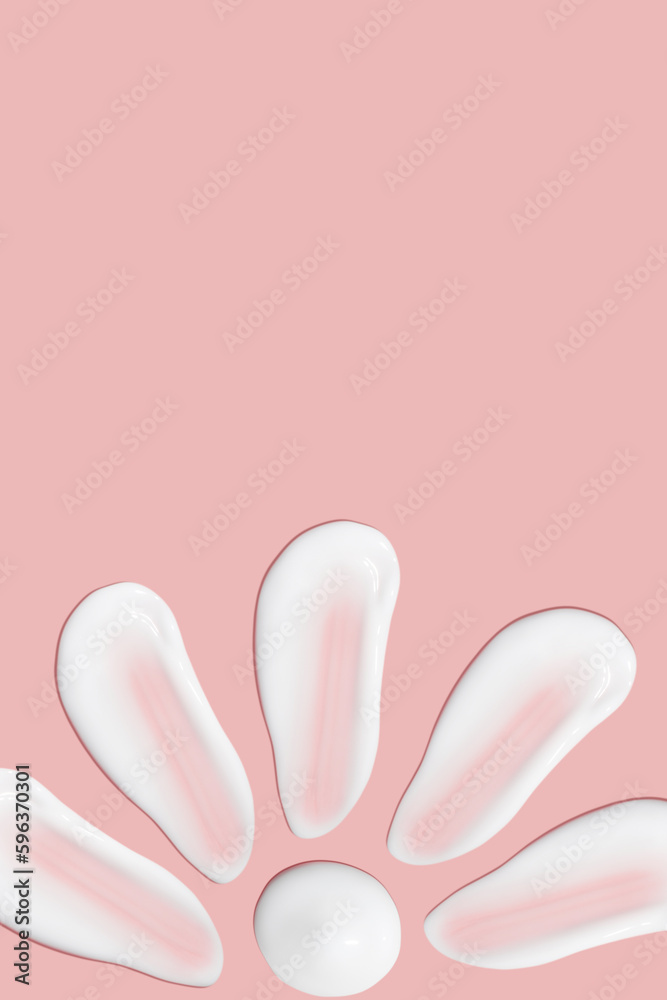 Lots of smears of cosmetic cream. Light, smooth surface. Texture of spreadable cream. Liquid creamy strokes. On a pink background. Cosmetic background, banner. Lots of smears of cosmetic cream. Light, smooth surface. Texture of spreadable cream. Liquid creamy strokes. On a pink background. Cosmetic background, banner.