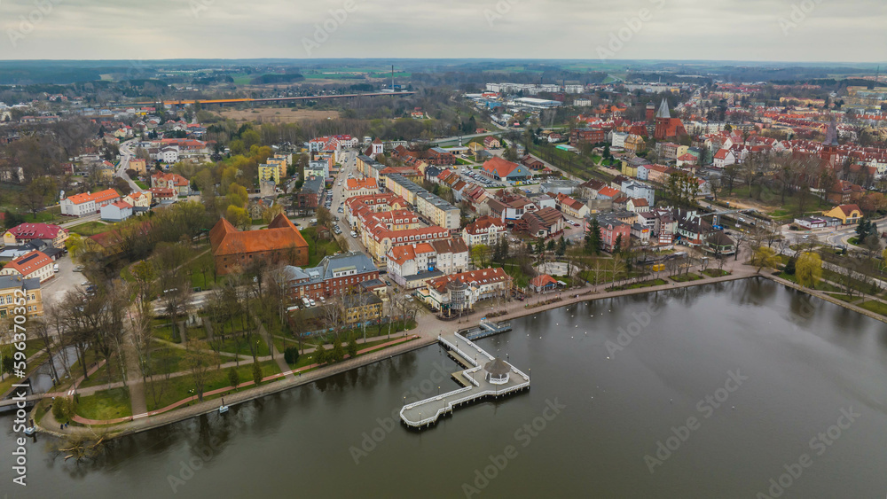 View of the pier in Ostróda and the panorama of the city on a cloudy spring day.