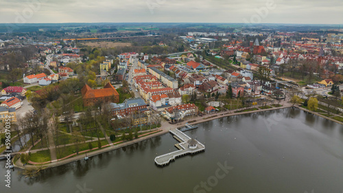 View of the pier in Ostróda and the panorama of the city on a cloudy spring day.