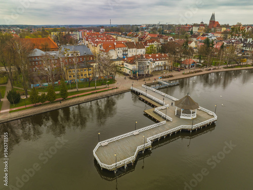 Fototapeta Naklejka Na Ścianę i Meble -  View of the pier in Ostróda and the panorama of the city on a cloudy spring day.