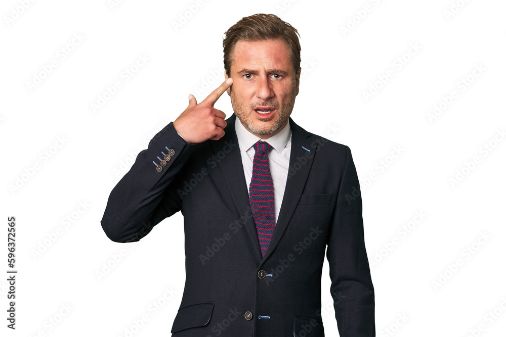 A middle-aged businessman isolated showing a disappointment gesture with forefinger. A middle-aged businessman isolated showing a disappointment gesture with forefinger.