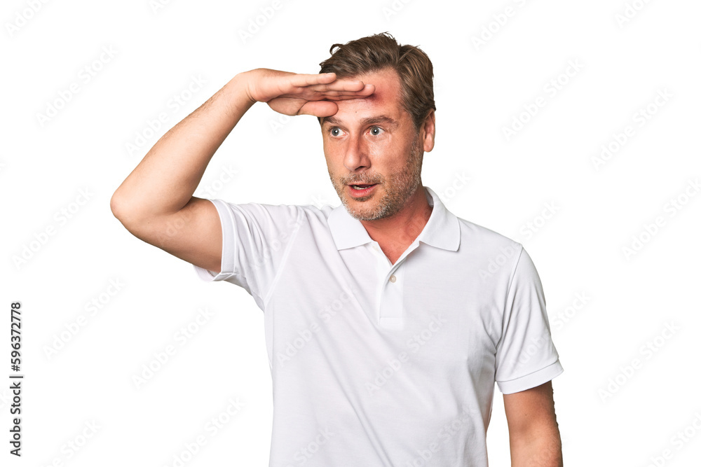 A middle-aged man isolated looking far away keeping hand on forehead. A middle-aged man isolated looking far away keeping hand on forehead.