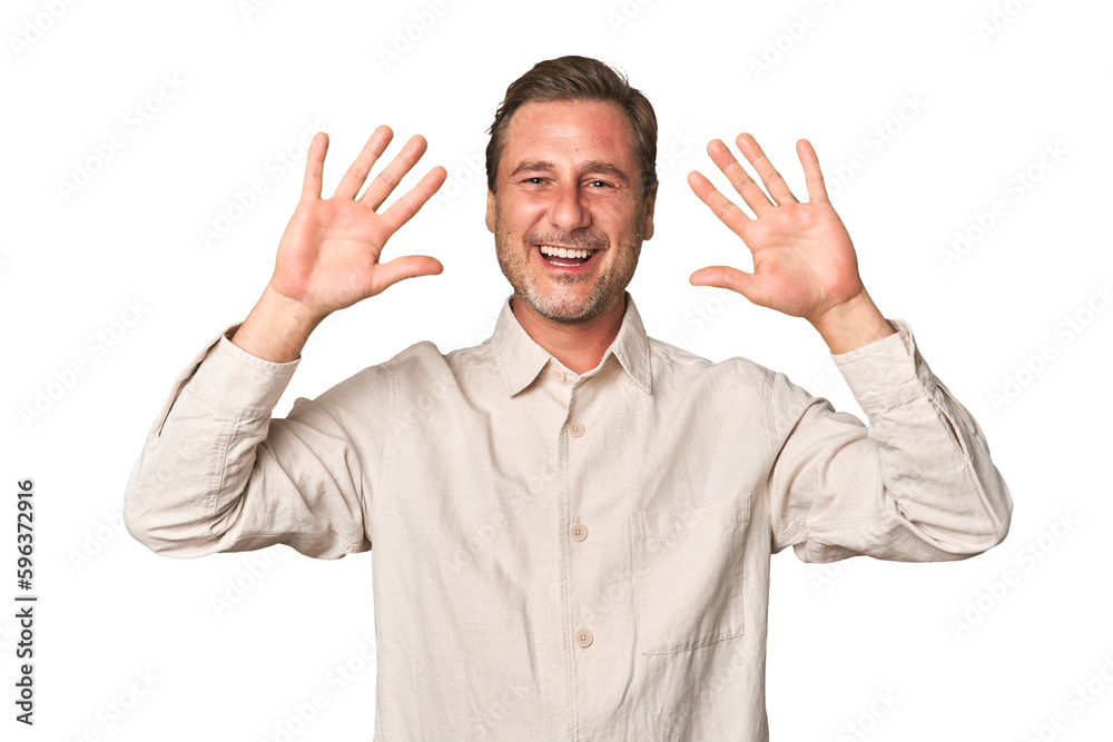 A middle-aged man isolated showing number ten with hands. A middle-aged man isolated showing number ten with hands.