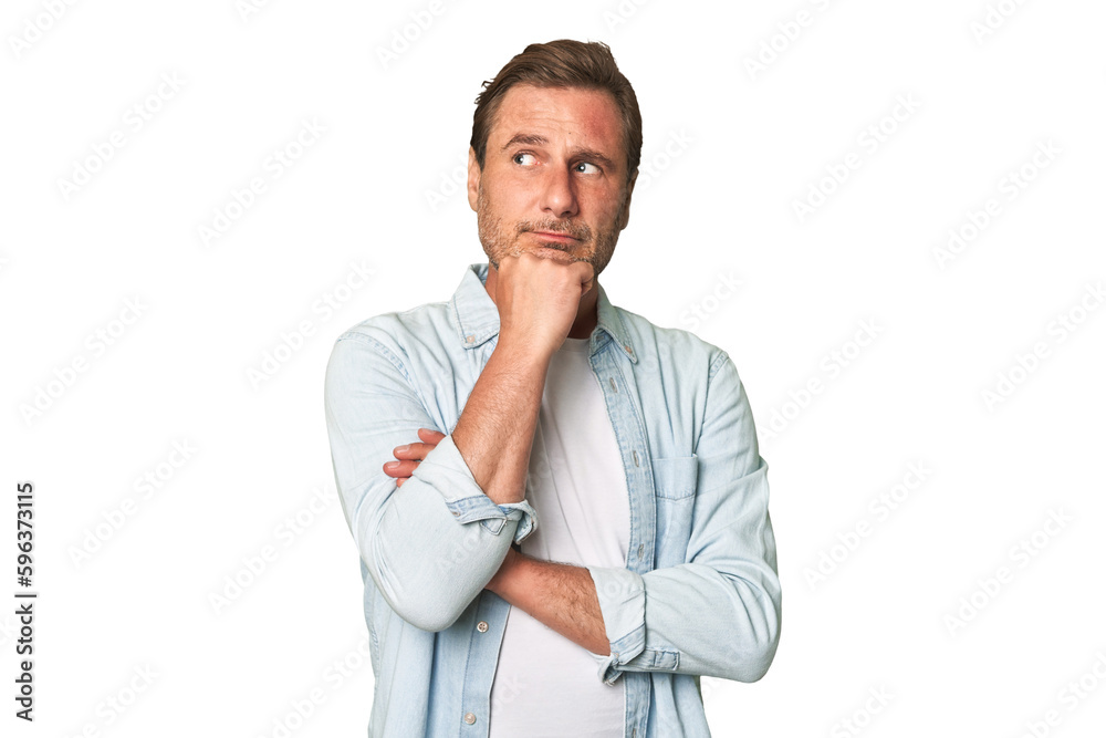 A middle-aged man isolated thinking and looking up, being reflective, contemplating, having a fantasy. A middle-aged man isolated thinking and looking up, being reflective, contemplating, having a fantasy.