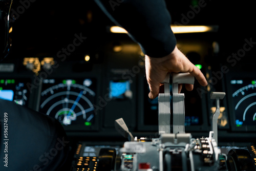 An airplane pilot controls the throttle during flight or takeoff View from inside the cabin