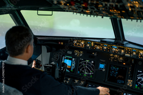 The pilot in the cockpit of the aircraft turbulence during the flight Flight simulator navigation devices © Guys Who Shoot