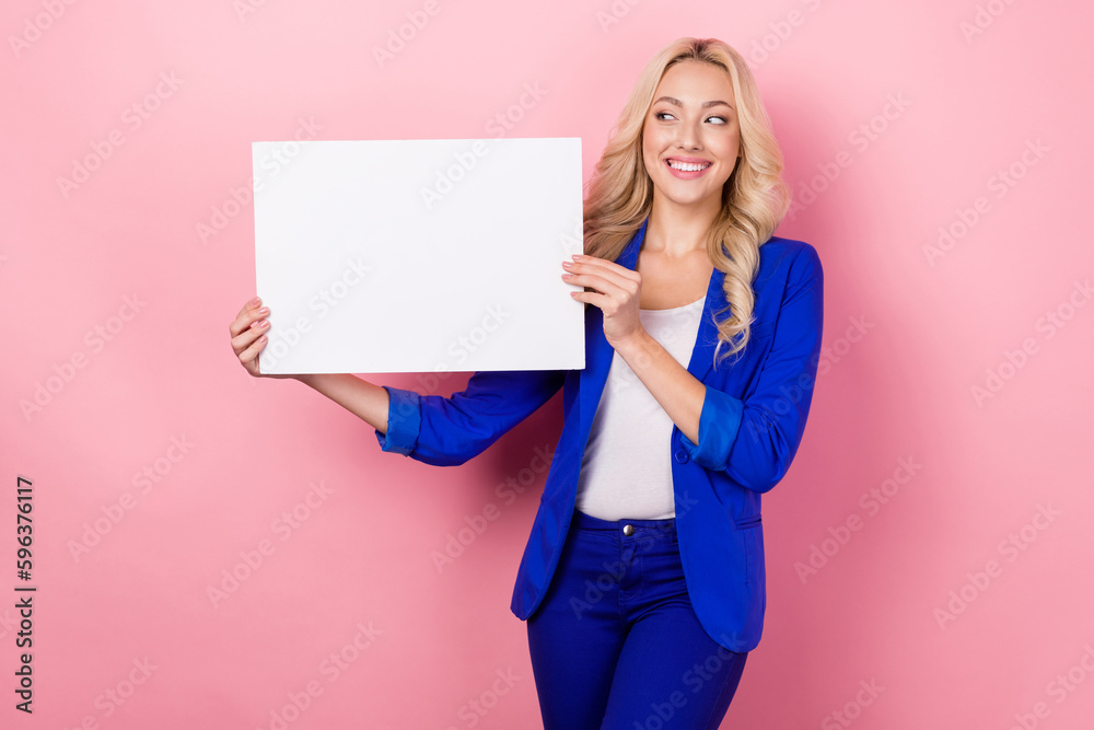 Photo of wavy blonde hair business manager wear blue suit hold paper placard empty space shopping day offer isolated on pink color background Photo of wavy blonde hair business manager wear blue suit hold paper placard empty space shopping day offer isolated on pink color background