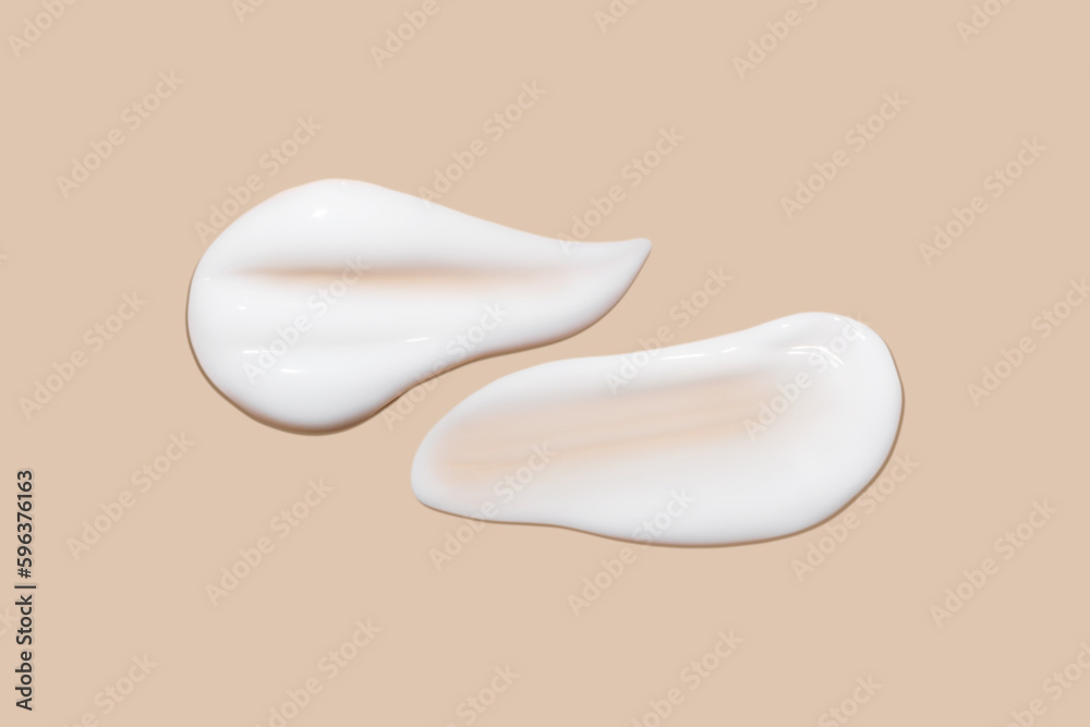 a set of strokes of white cream on a beige background. a set of strokes of white cream on a beige background.
