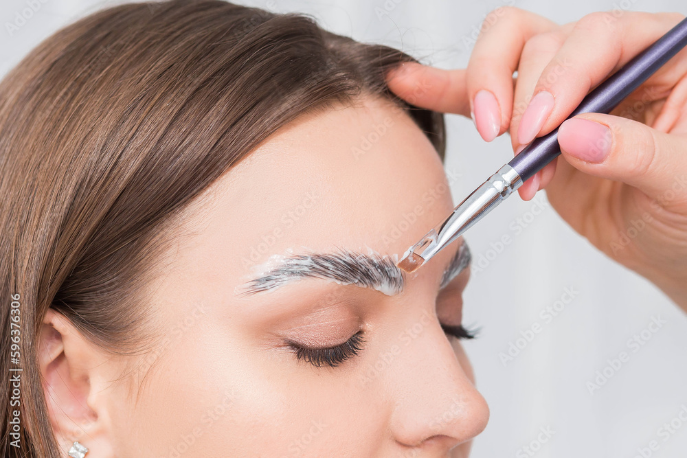 Process of long-lasting styling of the eyebrows and coloring the eyebrows. Eyebrow lamination. Professional make-up and face care. Process of long-lasting styling of the eyebrows and coloring the eyebrows. Eyebrow lamination. Professional make-up and face care.