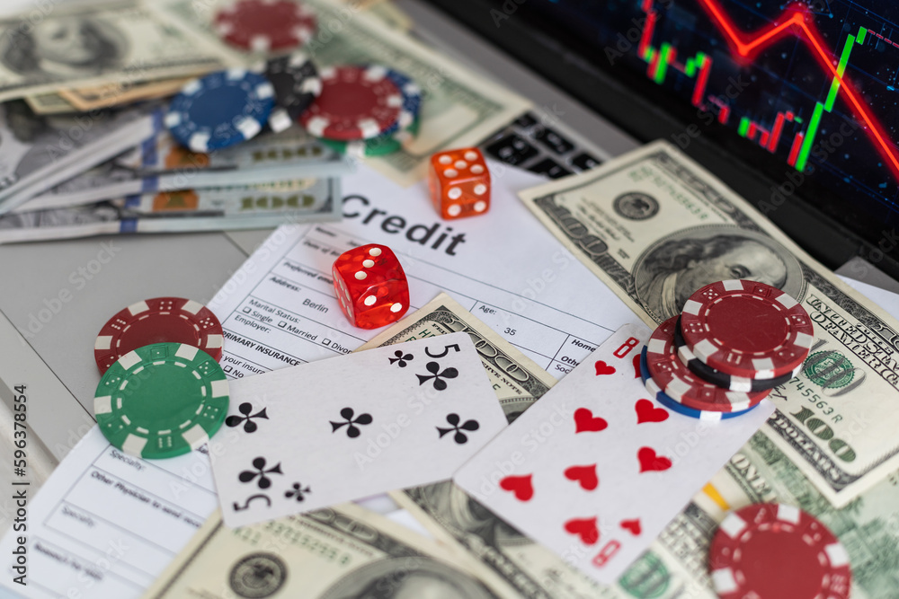 laptop with falling graph and casino chips laptop with falling graph and casino chips