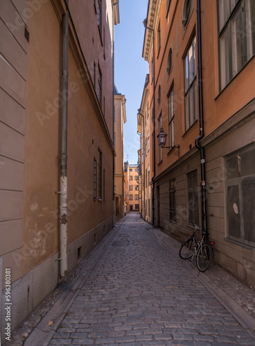 Alley view in the old town Gamla Stan facades and cobblestone street  a sunny spring day in Stockholm