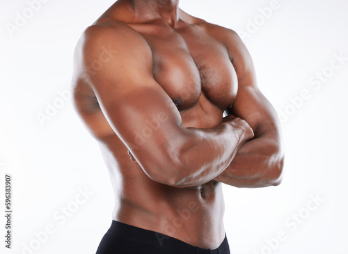 Im ready to take my fitness goals to the next level. Cropped shot of an unrecognisable man standing alone in the studio and posing with his arms folded.