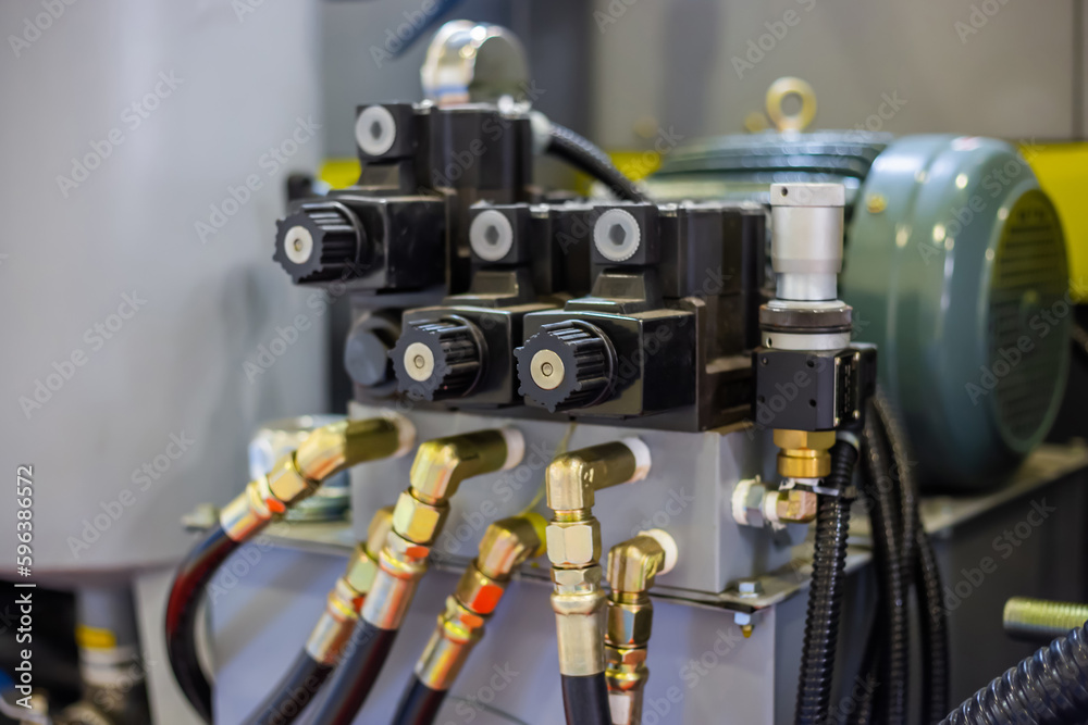 Part of automatic injection molding machine and flexible plastic hoses at exhibition, trade show. Manufacturing, production, technology concept Part of automatic injection molding machine and flexible plastic hoses at exhibition, trade show. Manufacturing, production, technology concept