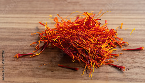 Saffron on Wooden Table - A Highly Prized Spice for Culinary and Medicinal Use, Savoring the Exotic Aroma and Taste of Saffron on Wooden Table, The Golden Spice: Saffron with copy space 