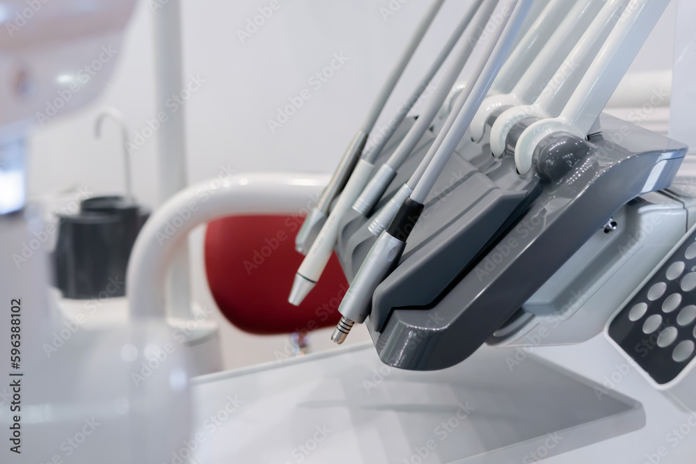 Different instruments and dentistry tools instruments in dental office, surgery - close up view. Stomatology, healthcare, medicine and equipment concept Different instruments and dentistry tools instruments in dental office, surgery - close up view. Stomatology, healthcare, medicine and equipment concept
