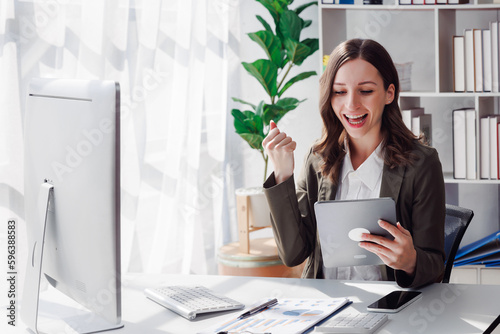 Overjoyed young businesswoman with digital tablet expressing excitement rejoicing in home office, Excited business woman feel euphoric reading good news online.