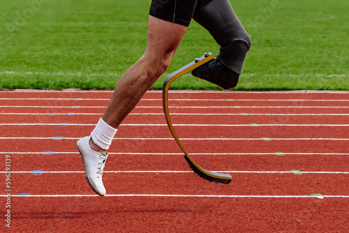 legs runner para-athlete on prosthesis running red track stadium, summer para athletics championships