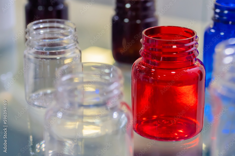 Medical empty colorful glass bottles in showcase at pharmaceutical exhibition, pharmacy laboratory. Pharma industry, science, medicine, experiment and healthcare concept Medical empty colorful glass bottles in showcase at pharmaceutical exhibition, pharmacy laboratory. Pharma industry, science, medicine, experiment and healthcare concept