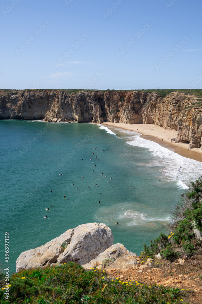 landscape view of the beach, sea and surfers at Praia do Belixe in Sagres Algarve Portugal 