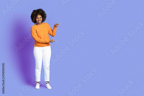 Cheerful stylish african american woman showing copy space for ad