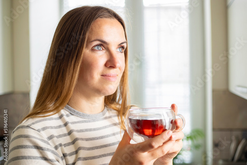 Woman holding a cup of hot tea in the morning