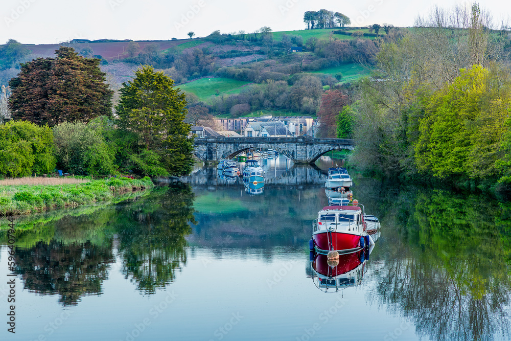 Boats on the River Dart in Totnes reflecting in the still water Boats on the River Dart in Totnes reflecting in the still water