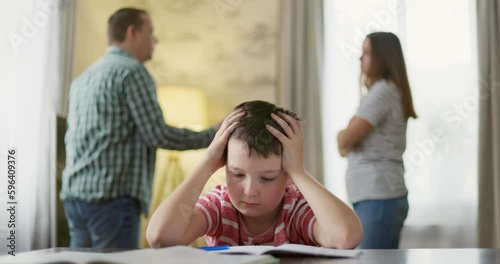 A son feels frustrated while his parents fight in the background