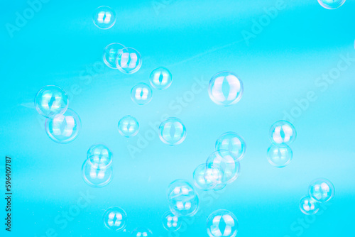 Soap bubbles on blue background blured selective