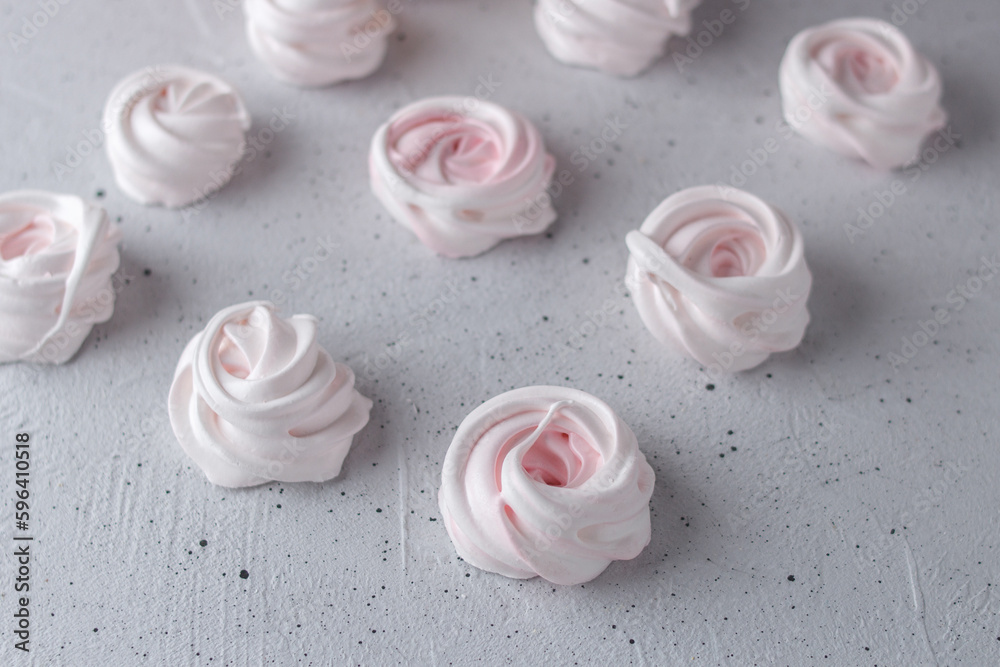 Meringue. Light dessert of whipped egg whites on a gray background.