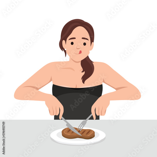 Young woman enjoy eating steak in the dish holding knife and fork as she is ready to eat.