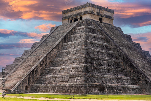 The castle and temple of Chichen Itza known as the famous Mayan pyramid of Mexico under an apocalyptic orange sky  belonging to the Mayan culture and civilization. Travel concept.