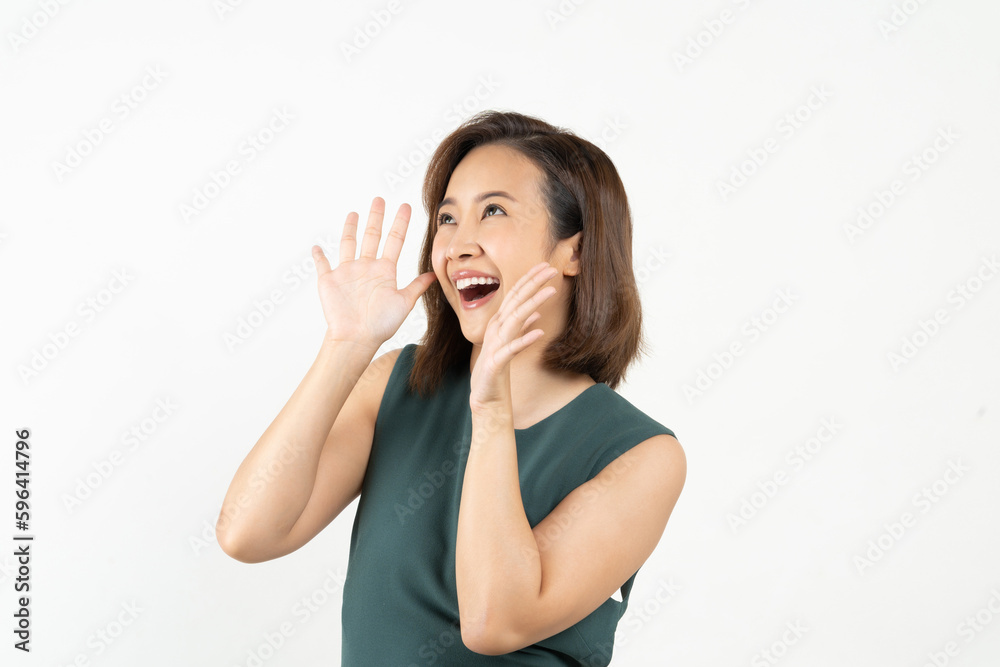 Young Asian woman doing a shocked surprise gesture shouting with hands cupped around mouth isolated white color background Young Asian woman doing a shocked surprise gesture shouting with hands cupped around mouth isolated white color background