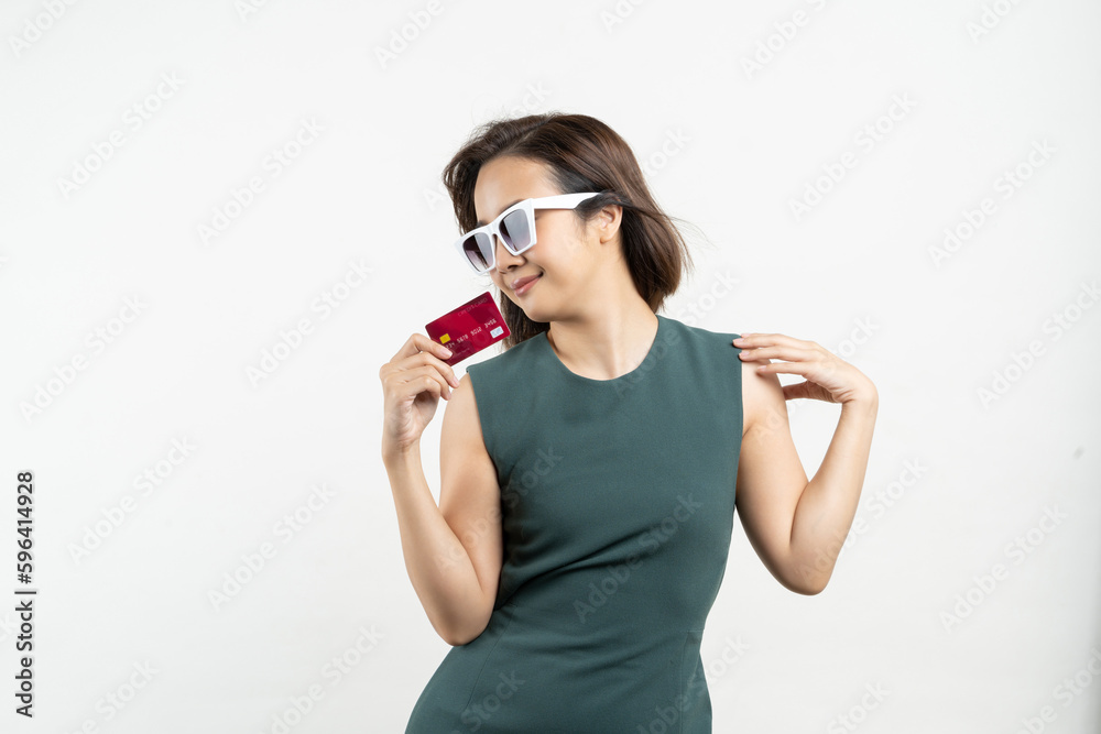 Young beauty Asian woman shopping payment online with credit card on smartphone studio shot on a white background. Young beauty Asian woman shopping payment online with credit card on smartphone studio shot on a white background.