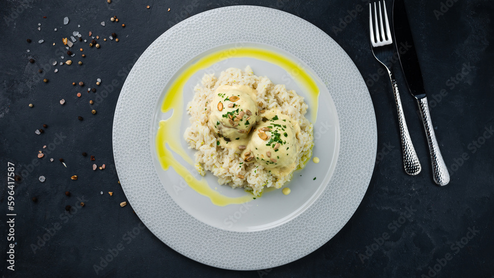 Pork meatballs with rice, milk sauce, seeds and herbs. Pork meatballs with rice, milk sauce, seeds and herbs.