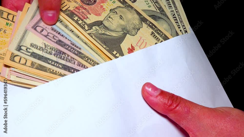 American dollor in a white cover counts banknotes with his hand