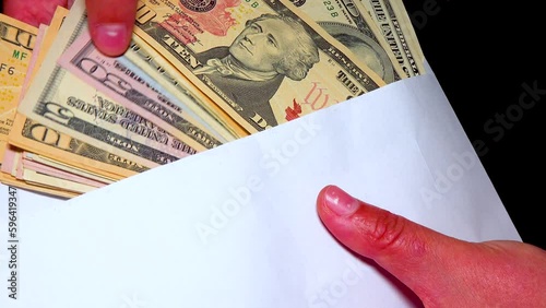 American dollor in a white cover counts banknotes with his hand