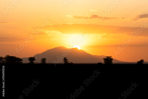 African landscape with mountains silhouettes and sunset, Amboseli National Park, Kenya.