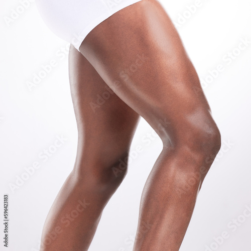 Hes on his way. Cropped shot of an unrecognizable man showing off his muscular legs while posing against a white background.